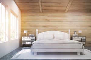 Front view of a double bed in a room with wooden walls and ceiling. There are two bedside tables and two large windows. 3d rendering. Mock up. Toned image