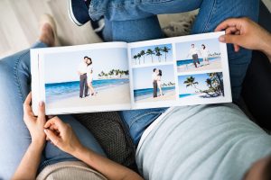 Couple Family Looking Photo Album Or Photobook