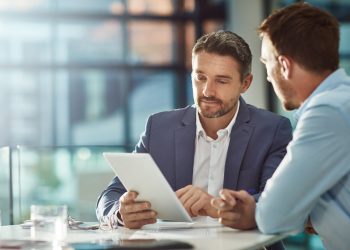 Teamwork meeting, tablet and business people in office workplace. Collaboration, technology and workers, men or employees with touchscreen planning sales, research or financial strategy in company.