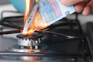 Gas price increase concept: 20 euro banknote burnt on a lit stove