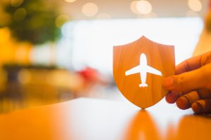 Shield protect icon with plane icon, Security protection. The concept of travel insurance, covering medical expenses, emergency medical evacuation, trip delays, trip interruptions, and lost baggage.