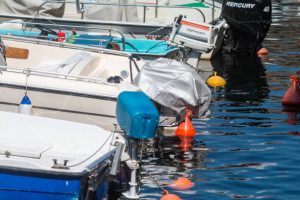 Varenna Harbor on Lake Como in Lombardy, Italy, with the engine manufacturers' names visible on the boats