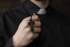 close-up-priest-holding-rosary