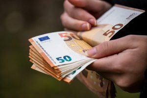 closeup-female-hands-counting-euro-banknotes-world-money-inflation-economy-concept