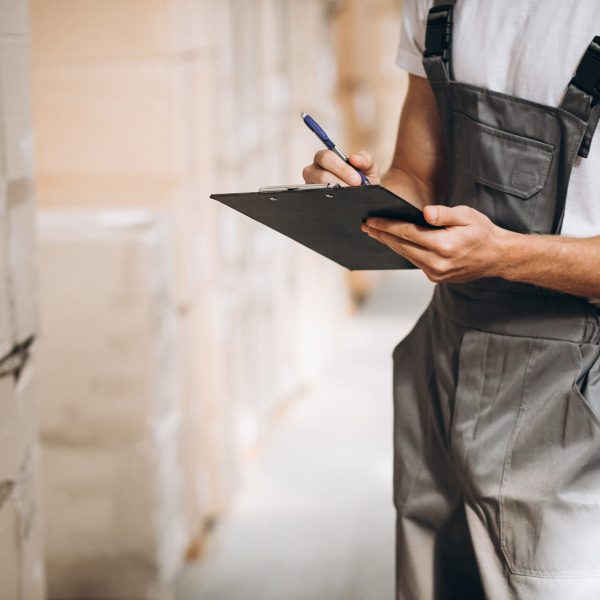 Young man working at a warehouse with boxes